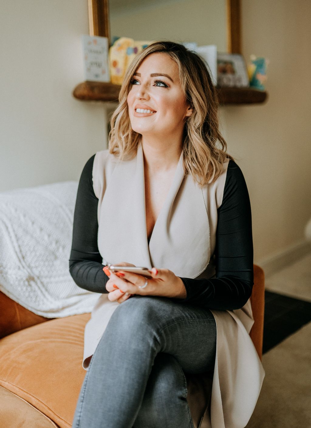 Young woman sitting in a cosy home smiling